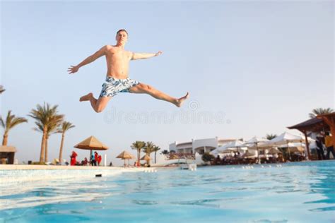 Man Jumping In Swimming Pool Stock Image Image Of Jump Male 13564633