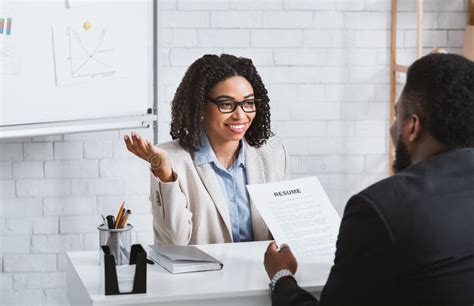 Friendly Personnel Manager Interviewing Black Candidate During Job Interview At Modern Office