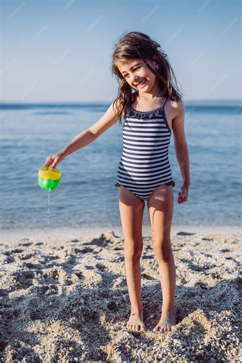 Premium Photo Cute Little Girl Playing On The Beach