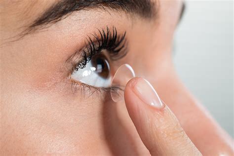 Woman Wearing Contact Lens At Home Review Of Optometric Business