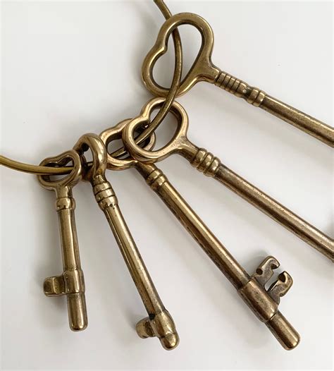giant brass skeleton key ring chain five keys vintage home decor design coffee table bookshelf