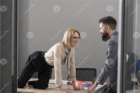 office romance concept secretary seduce boss in office businesswoman on desktop look at