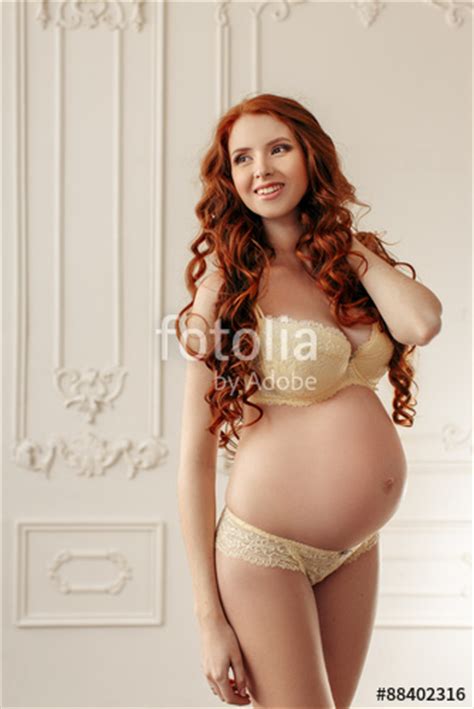 Pregnant Woman Smiling And Standing In Sexy Underwear