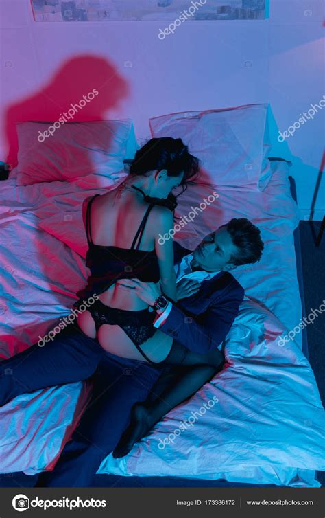 Passionate couple in bed — Stock Photo © IgorVetushko #173386172