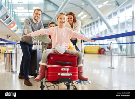 Girl Spreads Her Arms And Sits On Suitcases Before Departing At The