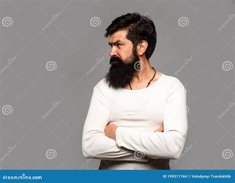 Portrait Of Confident Serious Man Has Beard And Mustache Looks