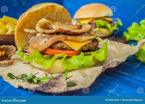 Great Hamburger And French Fries On A Wooden Table In Rustic Style