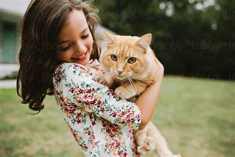 Little Girl Holding Cat By Stocksy Contributor Erin Drago Stocksy