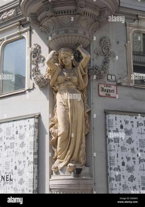 Plaster Statue Of Woman Holding Up The Building Adorning A Street