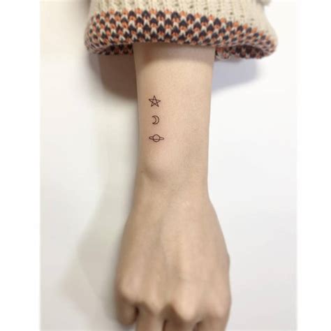 Minimalist Star Moon And Saturn Tattoo On The Wrist