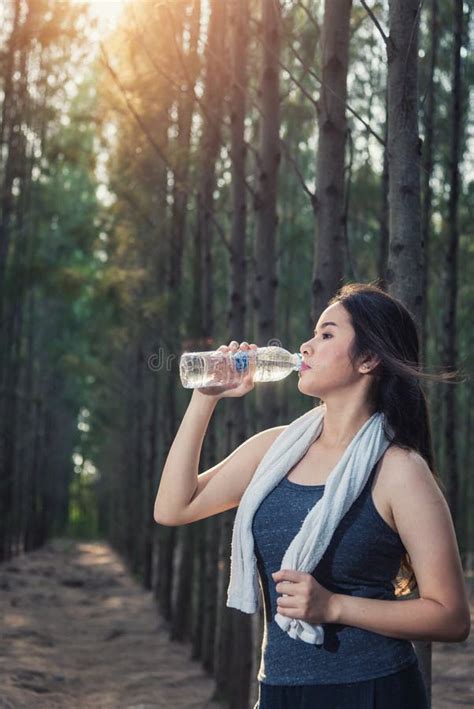 Beautiful Young Woman Drinking Water Bottle After Exercise Fitness