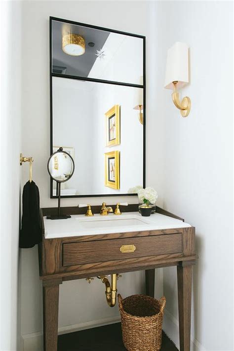 Brown And Gold Powder Room With Walnut Sink Vanity And Gold Sconces