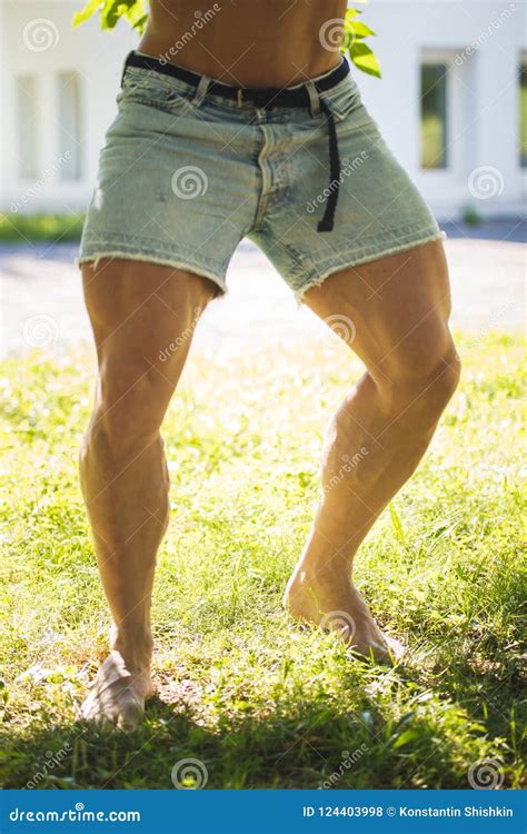 Strong Thick Legs Men Bodybuilder In Jean Shorts In Summer Park Stock