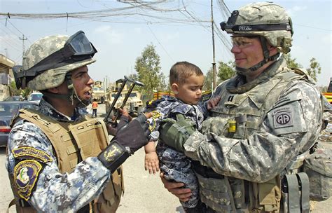 Us Army Capt Clay White Right Talks To An Iraqi Police Officer As