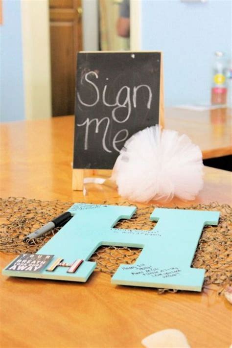 Stick the baby's ultrasound picture on a signing mat and ask the guests to sign it. Cool DIY Baby Shower Guest Book Ideas - Noted List