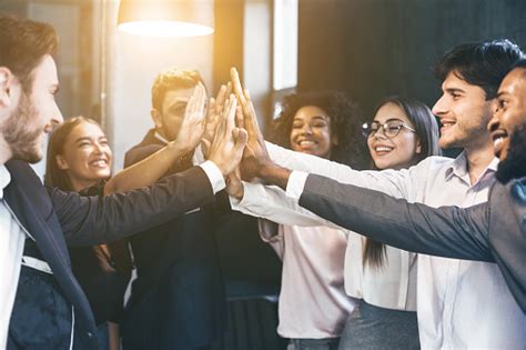 Happy Multiracial Business Team Giving High Fives Stock Photo