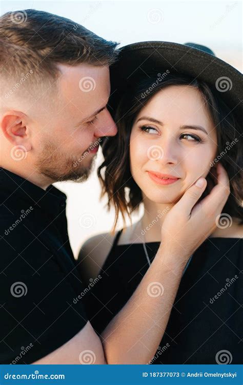Young Couple A Guy And A Girl With Joyful Emotions In Black Clothes