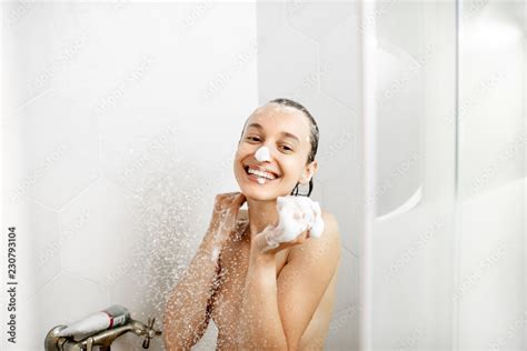Portrait Of A Happy Naked Woman Playing With Soap Foam In The Shower