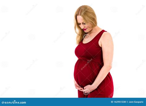 Pregnant Woman In Red Dress Holding Belly On White Background Stock