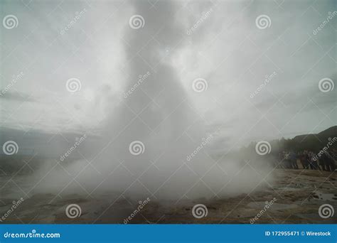 Beautiful Shot Of A Geyser With People Standing Near It Stock Image