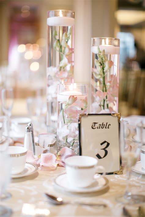 Floating Candle Centerpieces With Blush Orchids And Rose Gold Table Linens