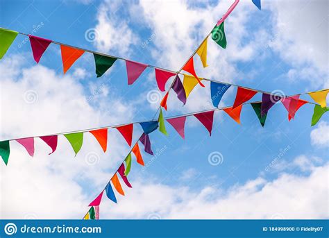 Small Colorful Triangular Flags Hanging On The Strings Against The Sky