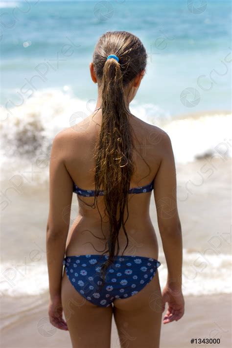 Slim Tanned Girl With Long Hair Goes To The Sea Stock Photo Crushpixel