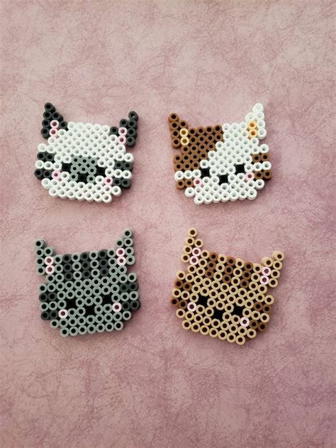 Four Perler Beads With Cats On Them
