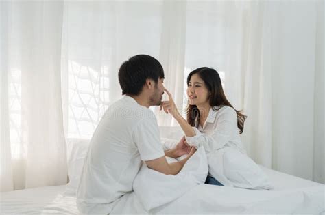 Asian Romantic Couple In Bed Enjoying Sensual Foreplay Happy Sensual