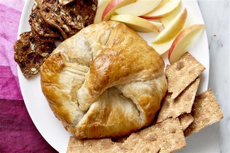 Place the brie in the center of the puff pastry and, one corner at a time, fold the pastry over the cheese so all four corners meet in the middle. How To Make Baked Brie in Puff Pastry | Kitchn
