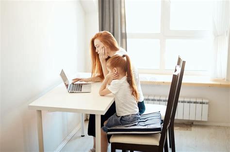 Red Haired Mom And Her Cute Daughter Watching Cartoons On Laptop Stock Image Image Of Cute