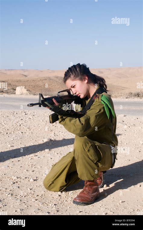 Israeli Young Female Soldier In Uniform Aiming Her M16 Rifle Stock
