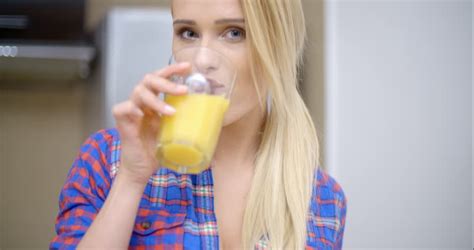 Sexy Bottomless Woman Wearing Blue Violet Shirt Only Drinking Orange Juice While At The Kitchen