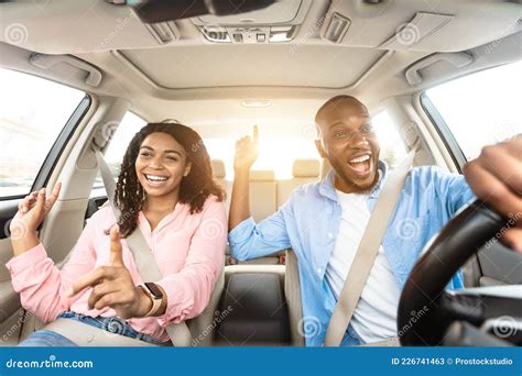 Happy Black Couple Enjoying Music Driving Luxury Car Stock Image