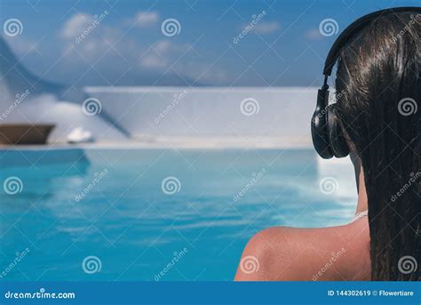 woman in the headphones listening to the music bathing in a pool stock image image of