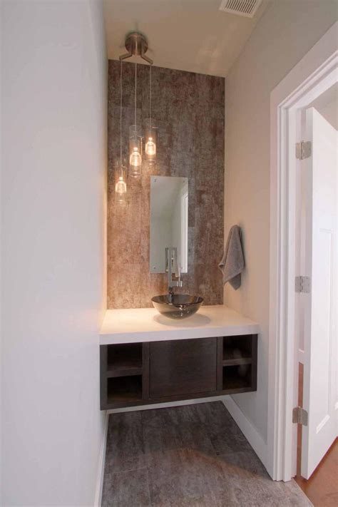 This unique mirror looks great as a powder room mirror, in entryways and bedrooms and is versatile thanks to its wooden frame. Modern Powder Room With Floating Vanity and Vessel Sink | HGTV