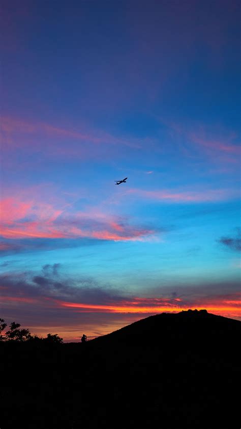 Download Wallpaper 938x1668 Silhouettes Plane Horizon Mountain