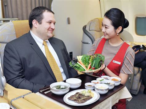 Stewardess Serves The Delicious Cabin Meal Of Asiana Airlines
