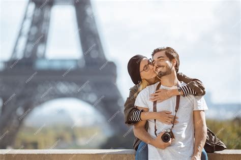 premium photo paris eiffel tower romantic couple embracing kissing in front of eiffel tower