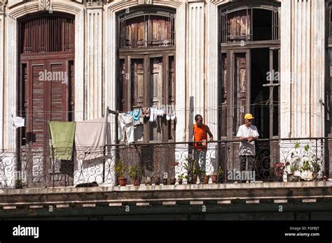 Daily Life In Cuba Cuban Men Leaning On Balcony Railings With Washing