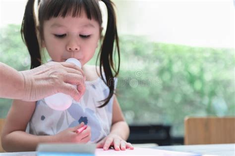Asian Girl 3 Year Old Is Drinking Milk From A Bottle Stock Image