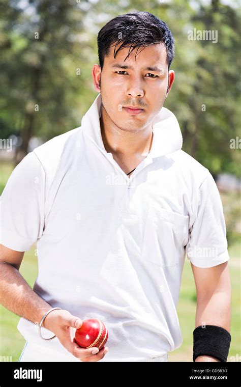 One Indian Young Man Bowler Holding Ball Playing Cricket In Play Ground