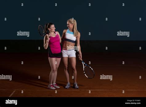 Portrait Of Two Beautiful Women Playing Tennis Indoor Isolated On
