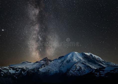 View Of The Night Sky Over Mount Rainier Featuring A Bright Milky Way