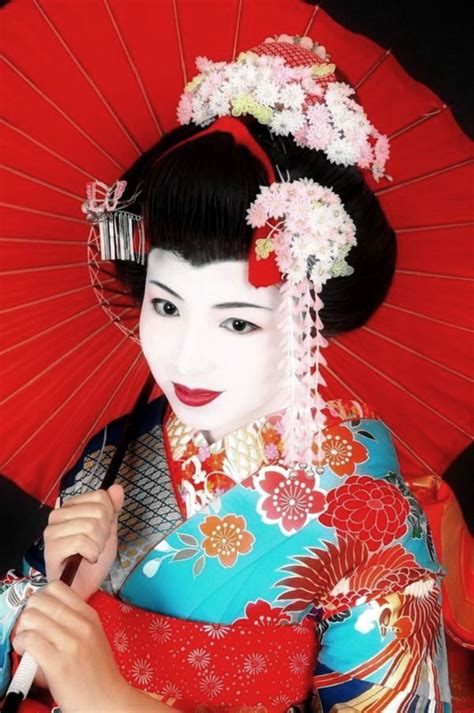 Archetypal Geisha Dressed In Kimono Complete With Hair Charms And White
