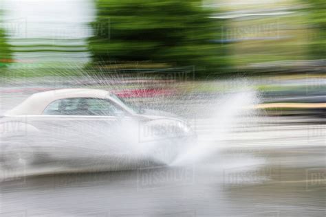 Car Splashing Water On Road Stock Photo Dissolve