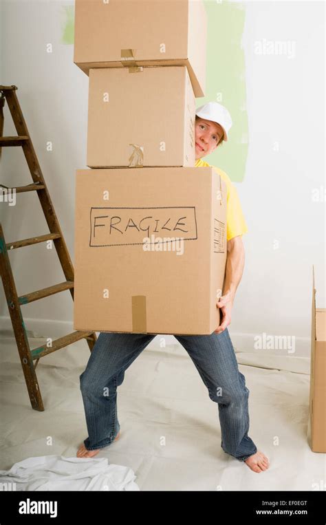 Man Carrying Heavy Boxes Stock Photo Alamy