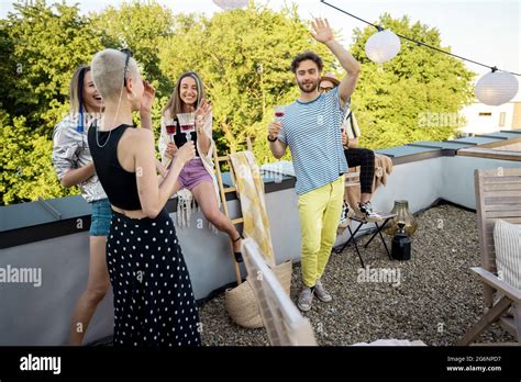 Stylish Friends At Party On The Roof Terrace Stock Photo Alamy