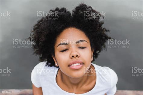 Closeup Shot Of Young Black Woman Smiling And Closing Her Eyes With