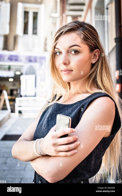Portrait Of Confident Young Woman On City Street Stock Photo Alamy